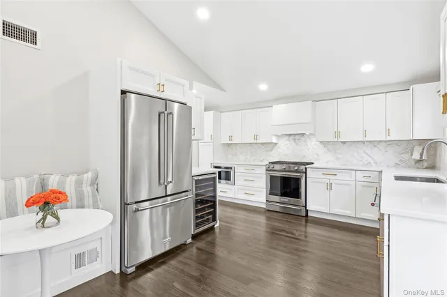 a kitchen with granite countertop stainless steel appliances and wooden cabinets