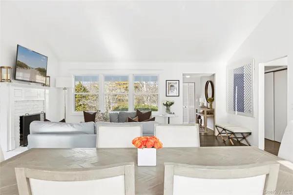 a bedroom with a bed a chandelier and a window