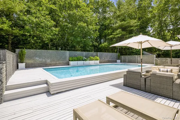 a view of a terrace with couches and pool