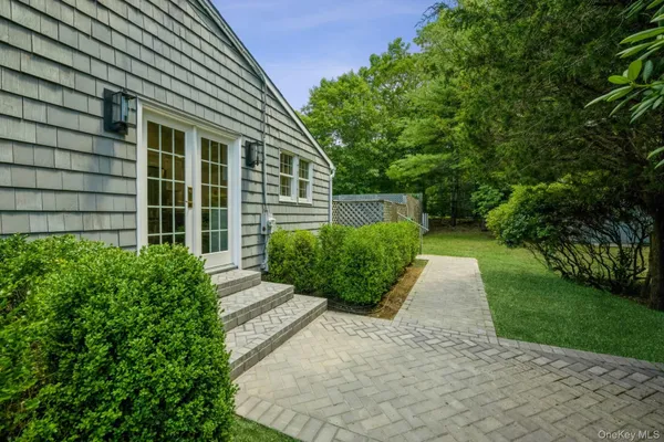 a view of a house with backyard and sitting area