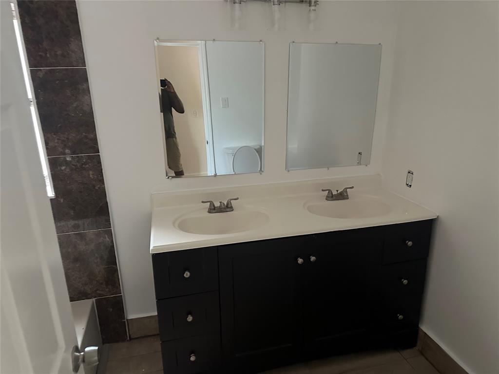 Margate Margate, FL 33068 - Photo 9 of 14 a bathroom with a double vanity sink and mirror