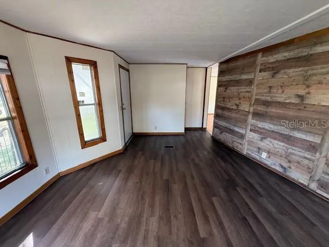 a view of wooden floor and windows in a room