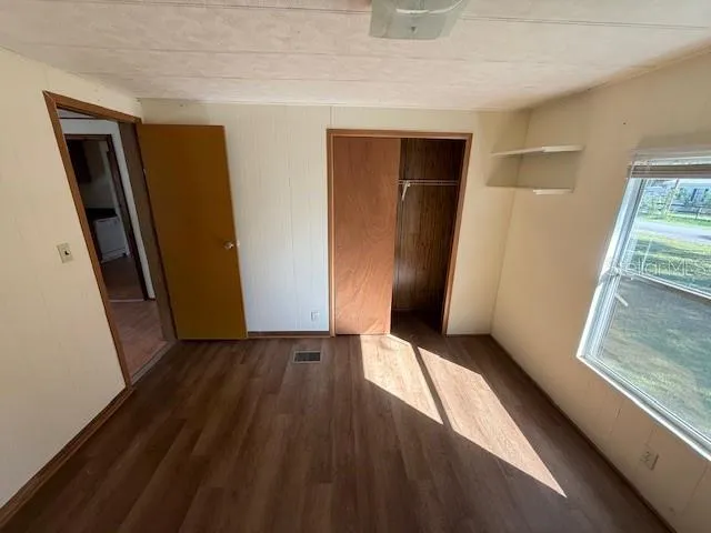 a view of hallway with wooden floor and stairs