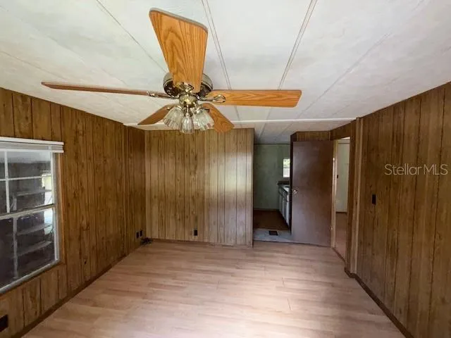 a bathroom with a granite countertop sink a mirror and shower