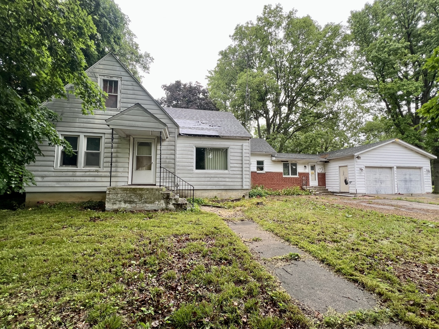 103 2nd Street Broadlands, IL 61816 - Photo 1 of 37 a white house that has a tree in front of it