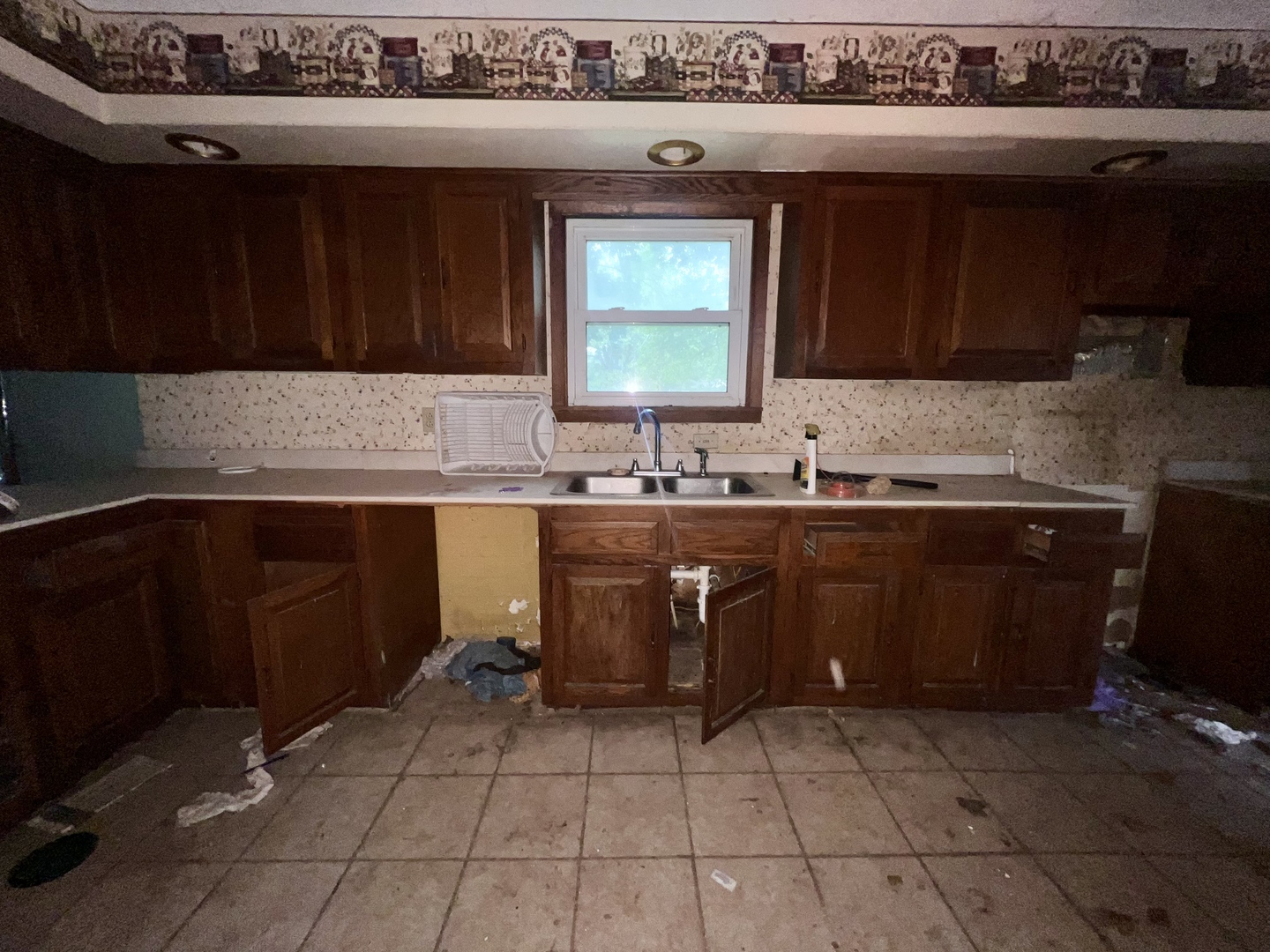 103 2nd Street Broadlands, IL 61816 - Photo 15 of 37 a kitchen with a sink a stove and wooden cabinets