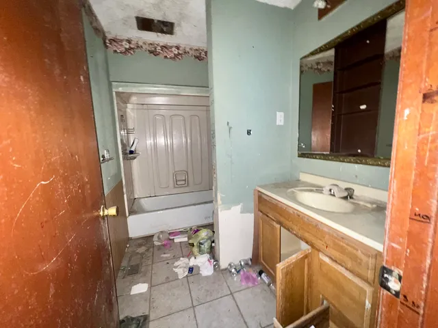 a bathroom with a sink a vanity and a mirror