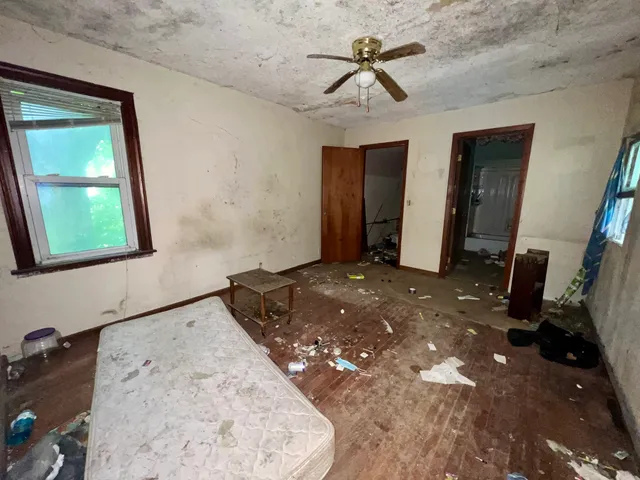 a bedroom with a bed and a mirror