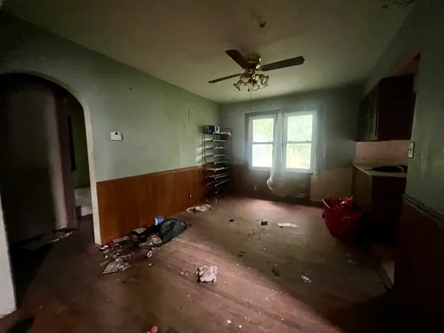 wooden floor in an empty room with a window