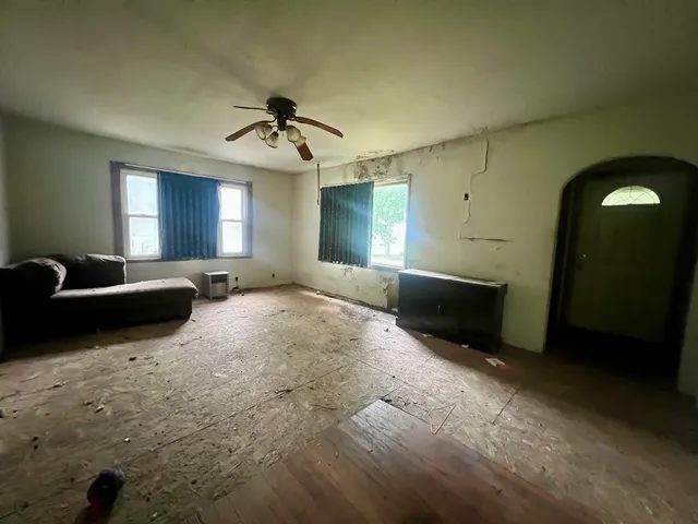 a large bedroom with a bed and a chandelier