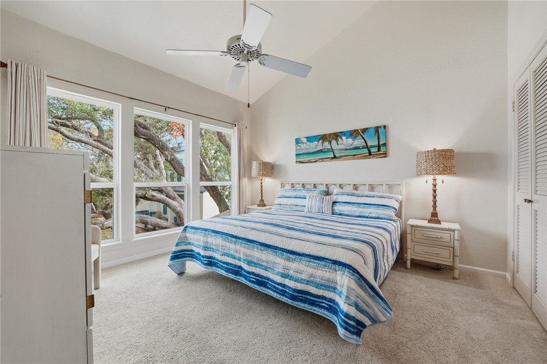 2003 North Fulton Beach Road, Unit 34 34 Rockport, TX 78382 - Photo 17 of 38 a spacious bedroom with a bed and a large window