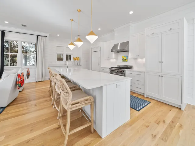 a kitchen with stainless steel appliances kitchen island granite countertop a stove a sink and a refrigerator