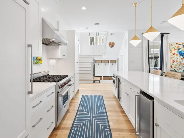 a kitchen with stainless steel appliances a stove a sink and a refrigerator