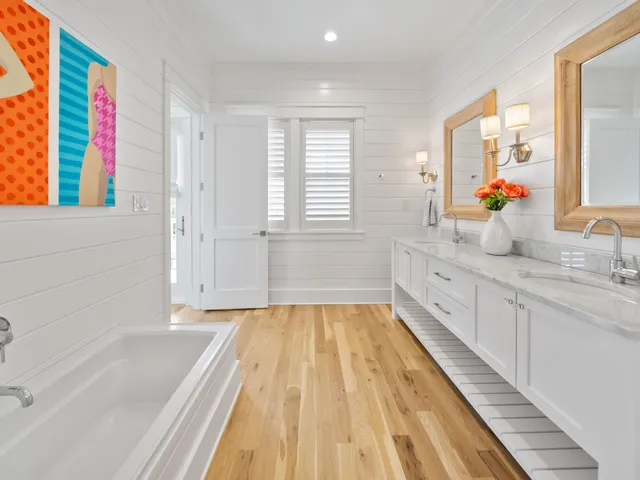 a living room with furniture floor to ceiling window and wooden floor