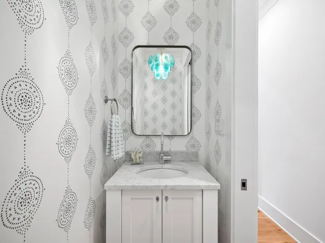 a bathroom with a sink and mirror with toilet