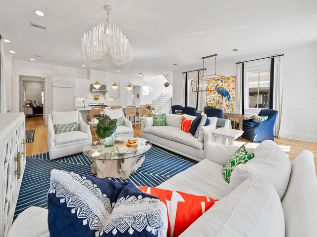 a living room with furniture and a chandelier