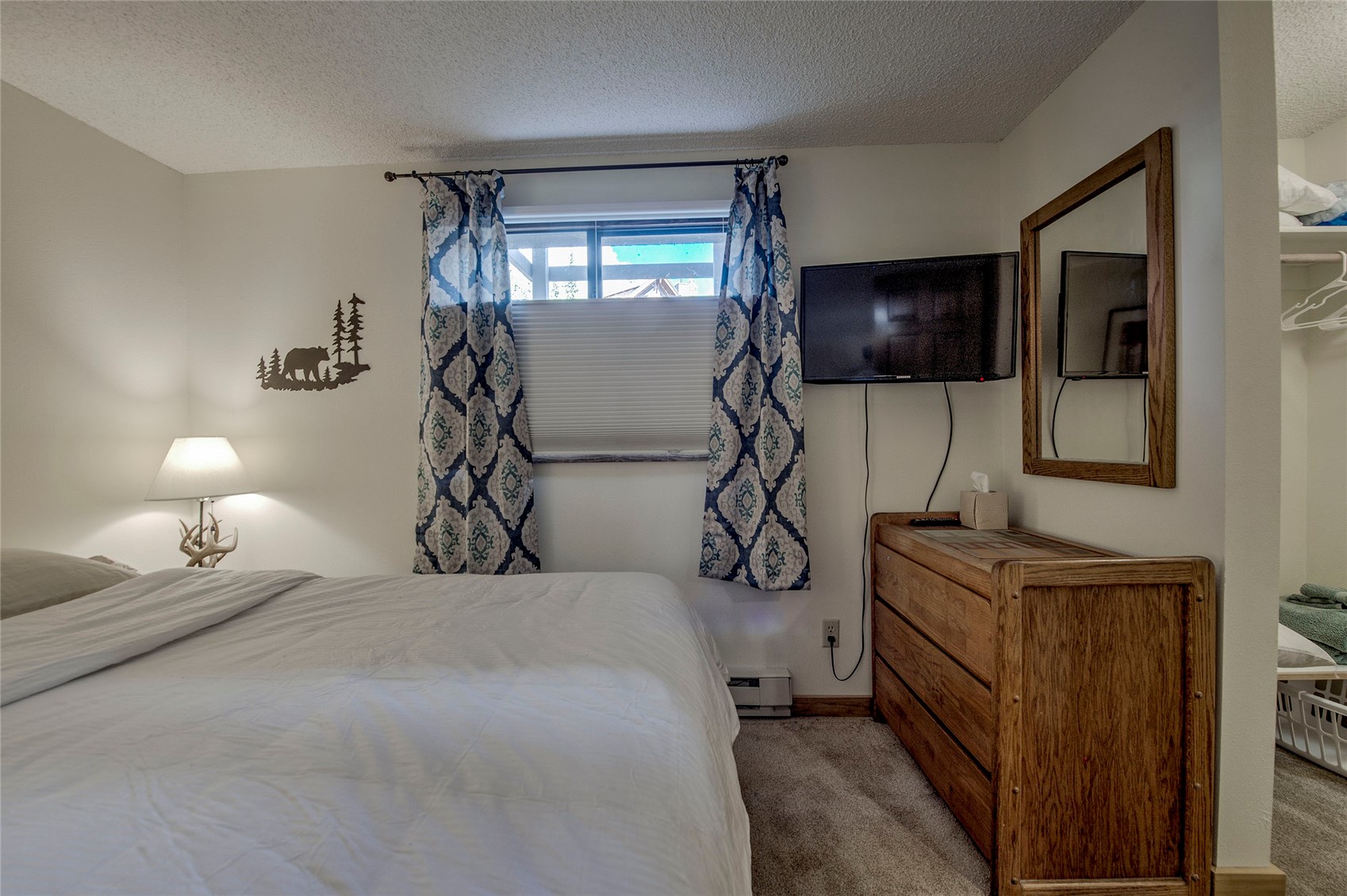 187 Fuller Placer Road, Unit B Breckenridge, CO 80424 - Photo 24 of 33 a bedroom with a bed and a flat screen tv