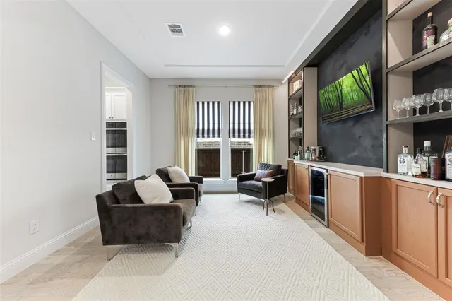 a living room with furniture fireplace and a large window