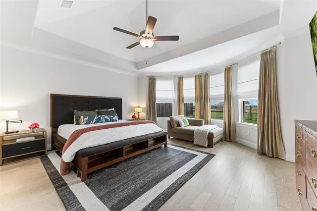 a bed room with a bed and a large window