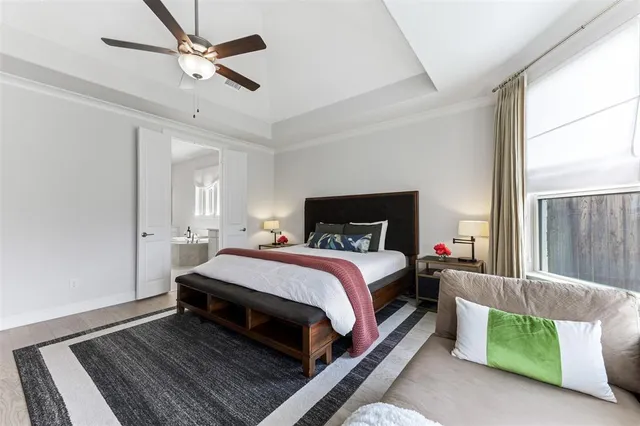 a bedroom with a bed lamp and a window