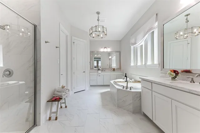 a spacious bathroom with a sink mirror and a bathtub