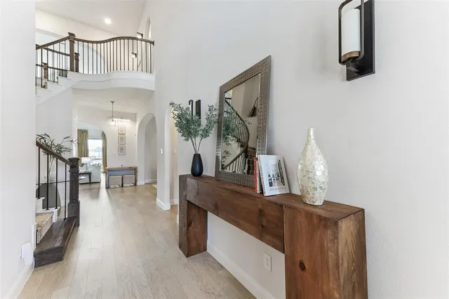 a living room with furniture a flat screen tv and a wooden floor