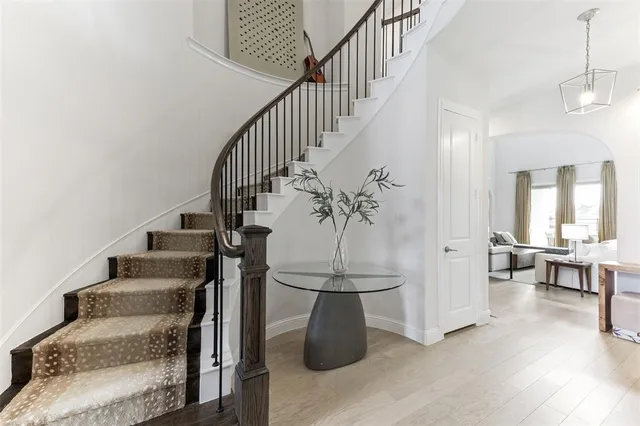 a view of entryway and hall with wooden floor