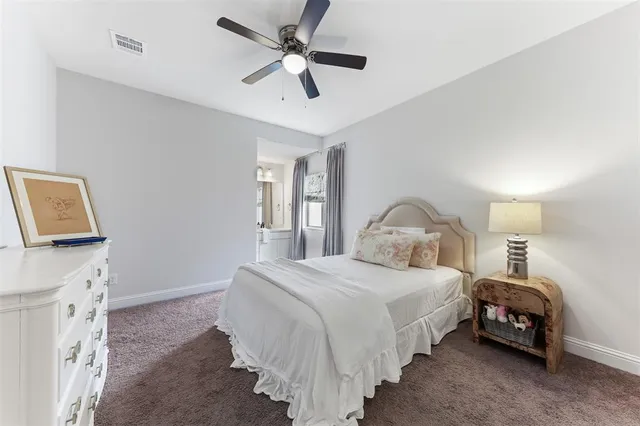 a bedroom with bed and a chandelier