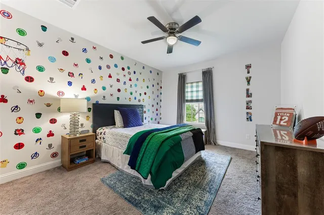 a bedroom with a bed a couch and a bookshelf