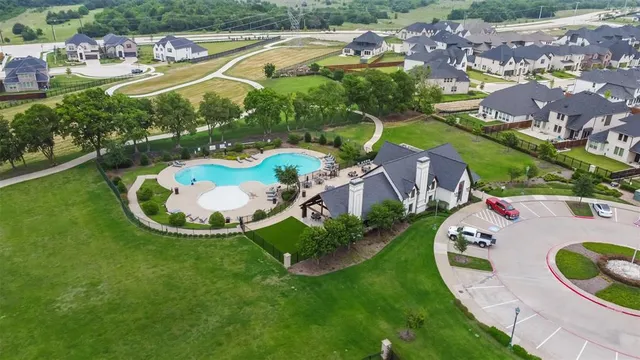 an aerial view of residential house with outdoor space and swimming pool