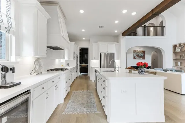 a kitchen with stainless steel appliances granite countertop a sink and cabinets