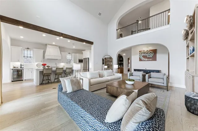 a living room with furniture and a view of kitchen