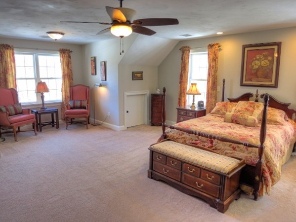 73 Front Street Hopkinton, MA 01748 - Photo 18 of 30 a spacious bedroom with a bed and a chandelier