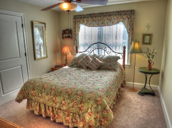 73 Front Street Hopkinton, MA 01748 - Photo 22 of 30 a bedroom with a bed and a chandelier