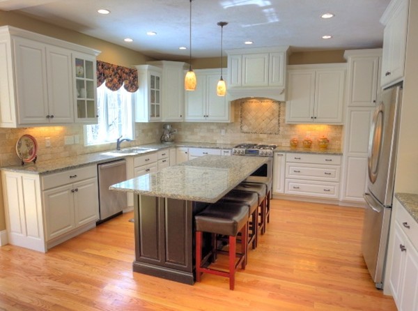 73 Front Street Hopkinton, MA 01748 - Photo 9 of 30 a kitchen with kitchen island granite countertop wooden floors and white cabinets