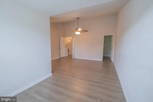 a spacious bathroom with a granite countertop sink a mirror and a bathtub