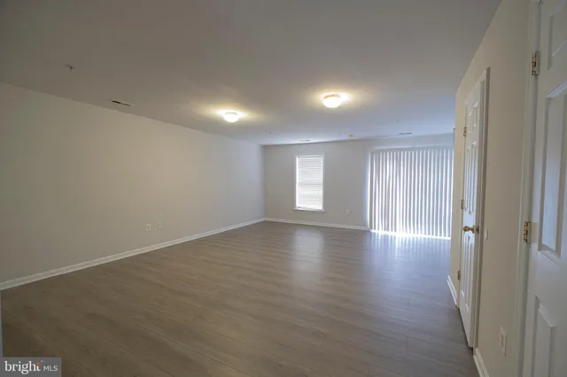 a view of a backyard with wooden fence