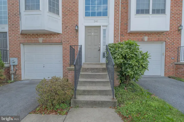 a view of a big room with wooden floor and windows