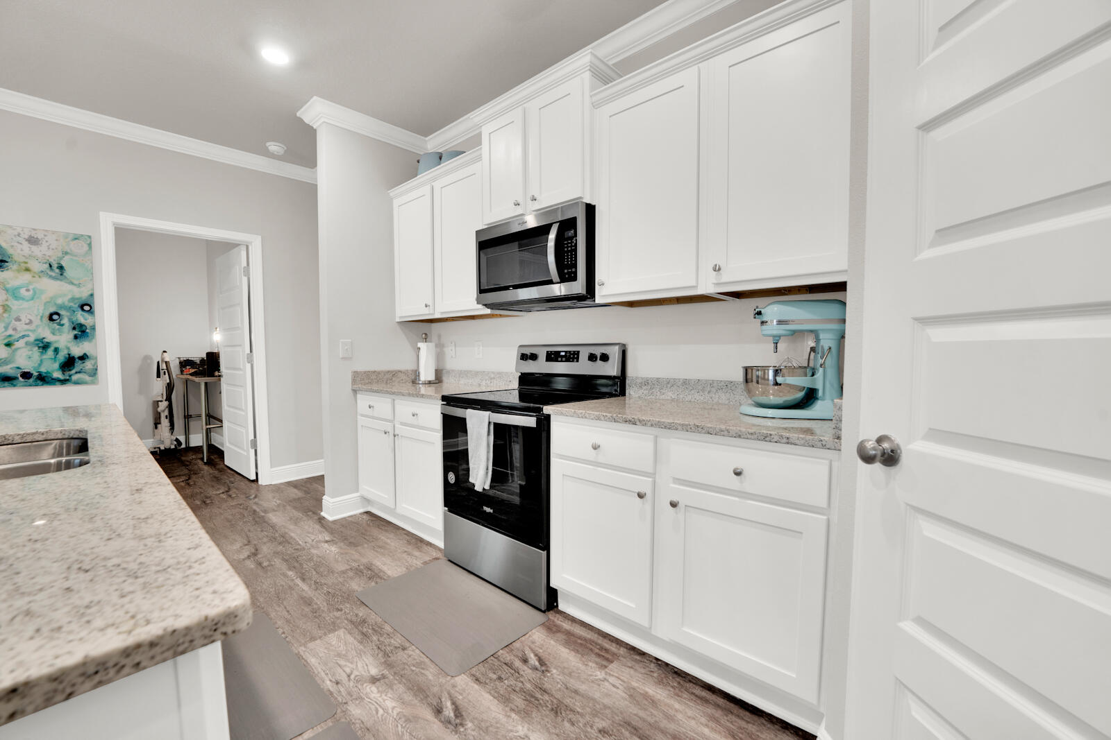451 Lightning Bug Lane Freeport, FL 32439 - Photo 22 of 47 a kitchen with granite countertop white cabinets and stainless steel appliances