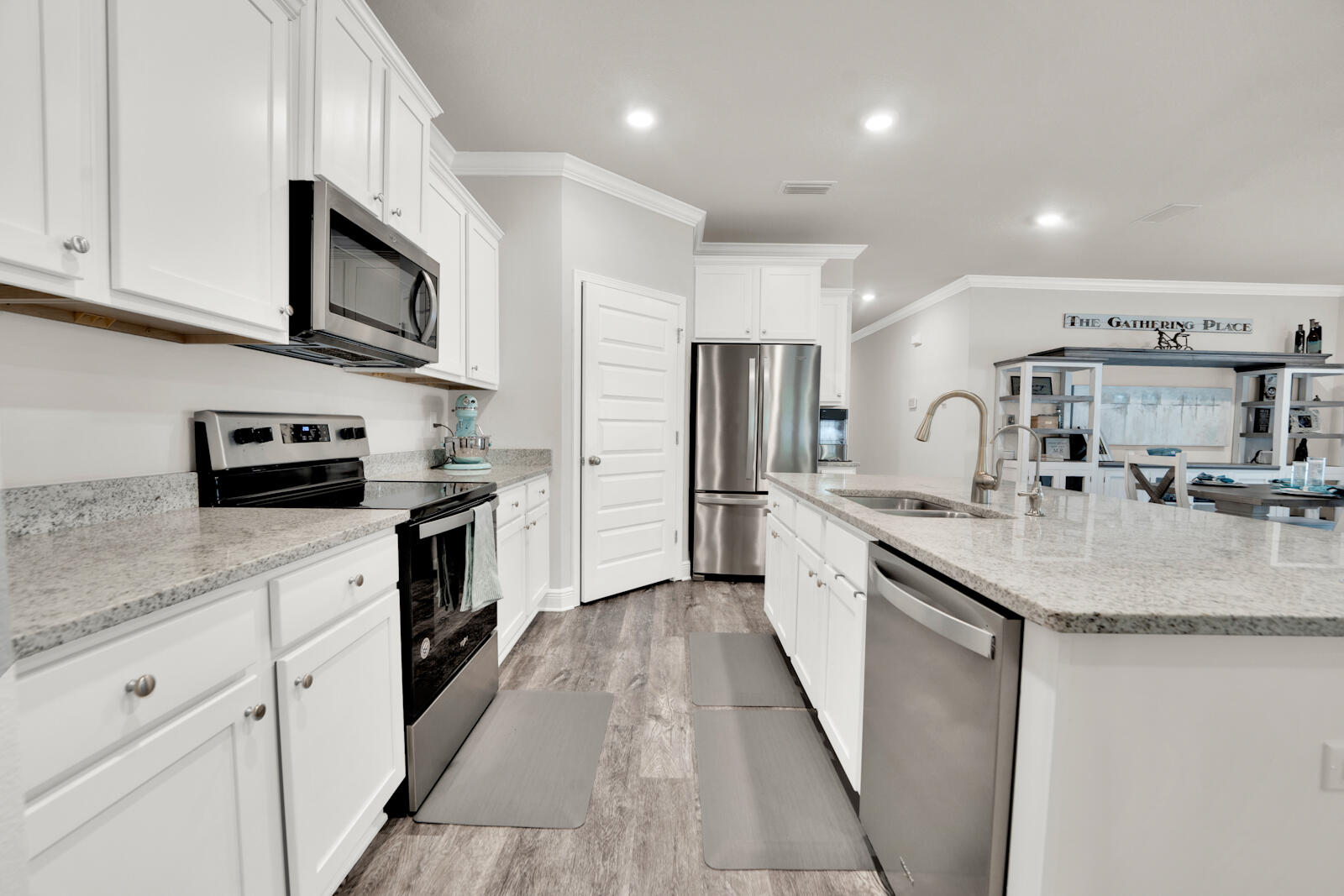 451 Lightning Bug Lane Freeport, FL 32439 - Photo 23 of 47 a kitchen with stainless steel appliances granite countertop a sink stove and cabinets
