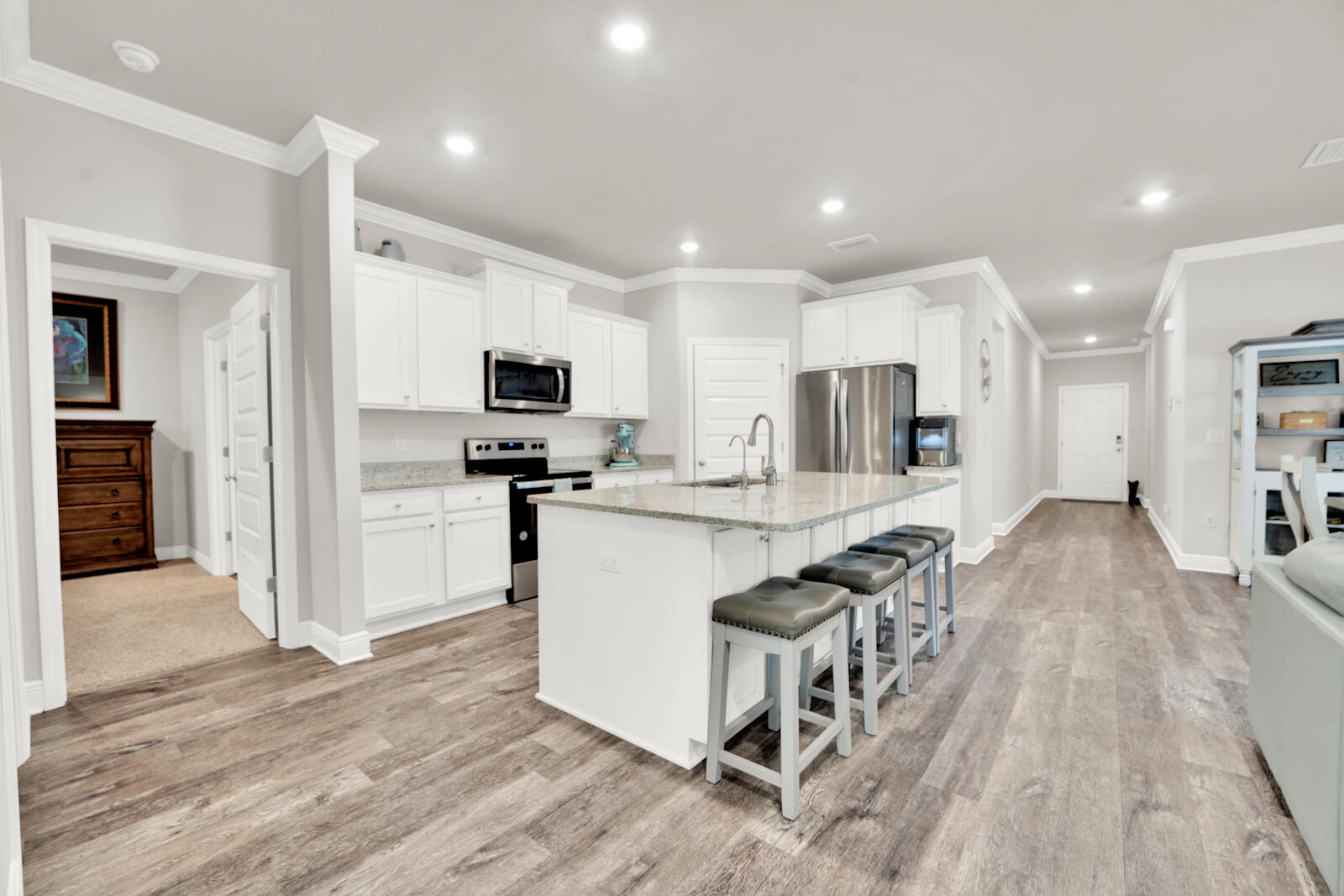 451 Lightning Bug Lane Freeport, FL 32439 - Photo 24 of 47 a kitchen with granite countertop a refrigerator stove microwave and cabinets