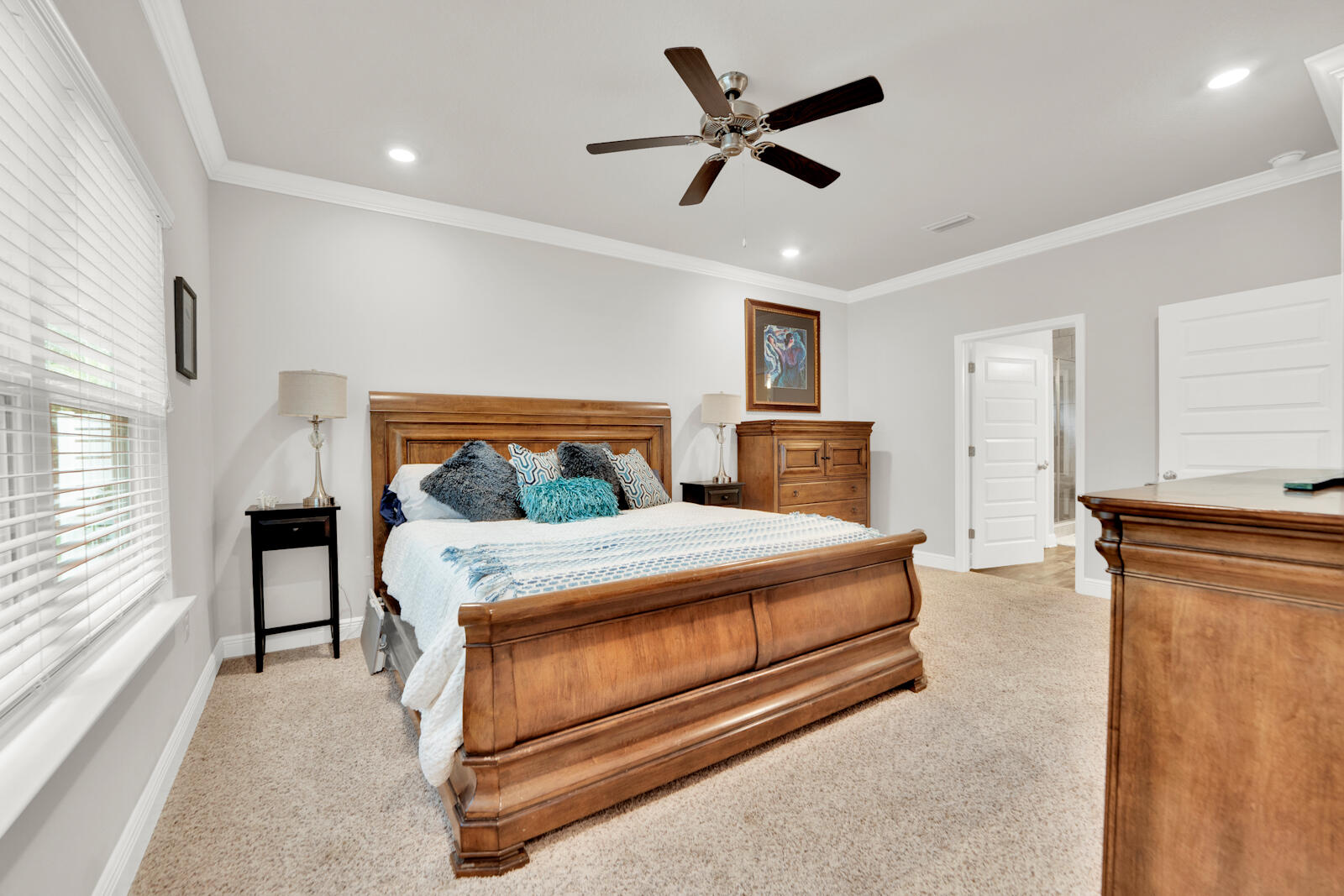 451 Lightning Bug Lane Freeport, FL 32439 - Photo 27 of 47 a bedroom with a large bed and a chandelier