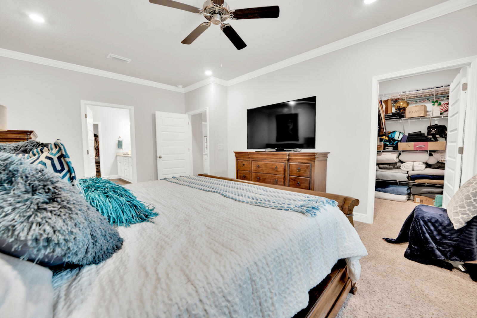 451 Lightning Bug Lane Freeport, FL 32439 - Photo 29 of 47 a bedroom with a bed and a flat tv screen on dresser