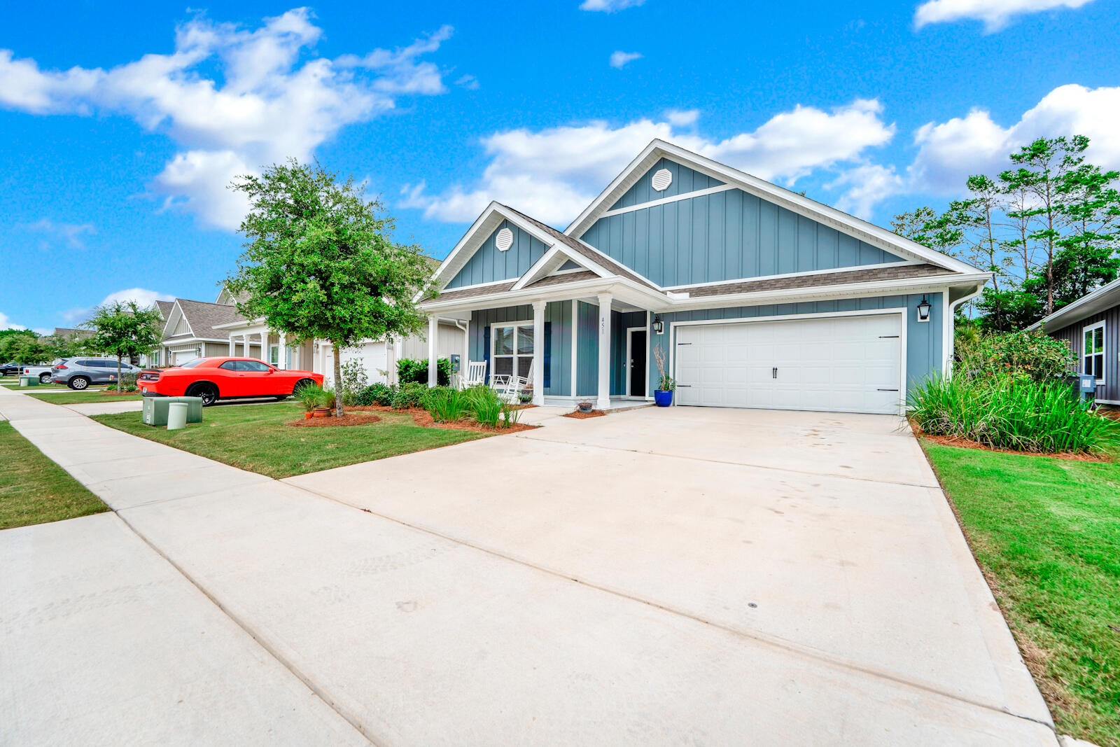 451 Lightning Bug Lane Freeport, FL 32439 - Photo 4 of 47 a front view of a house with a yard and potted plants