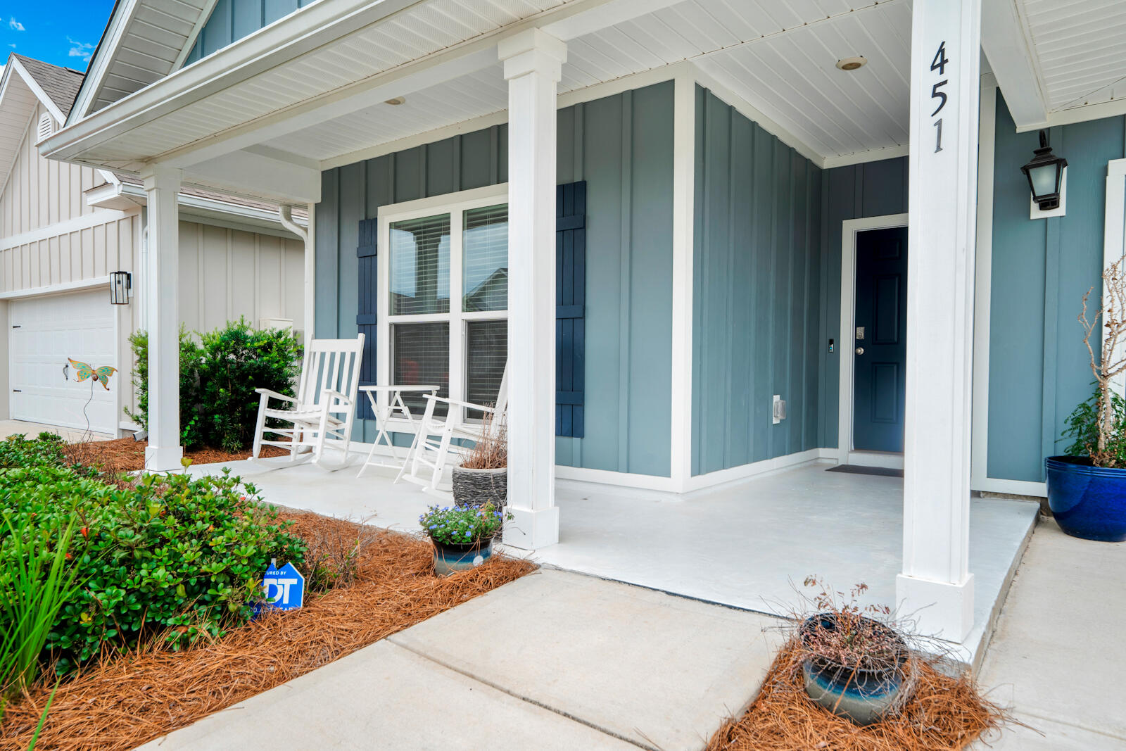 451 Lightning Bug Lane Freeport, FL 32439 - Photo 5 of 47 a front view of a house with outdoor seating and plants