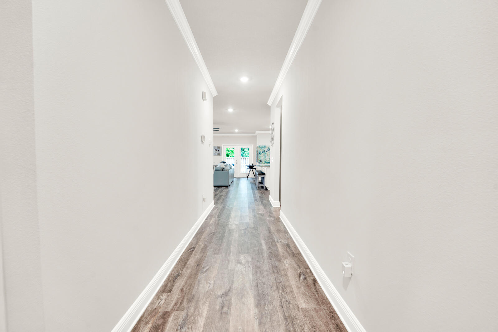 451 Lightning Bug Lane Freeport, FL 32439 - Photo 8 of 47 a view of a hallway with wooden floor and a bathroom