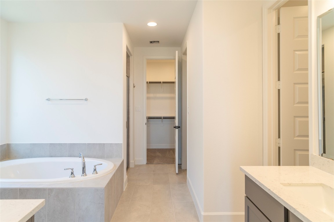 29856 Smoky Ridge Road Fulshear, TX 77441 - Photo 12 of 36 a bathroom with a tub sink and mirror