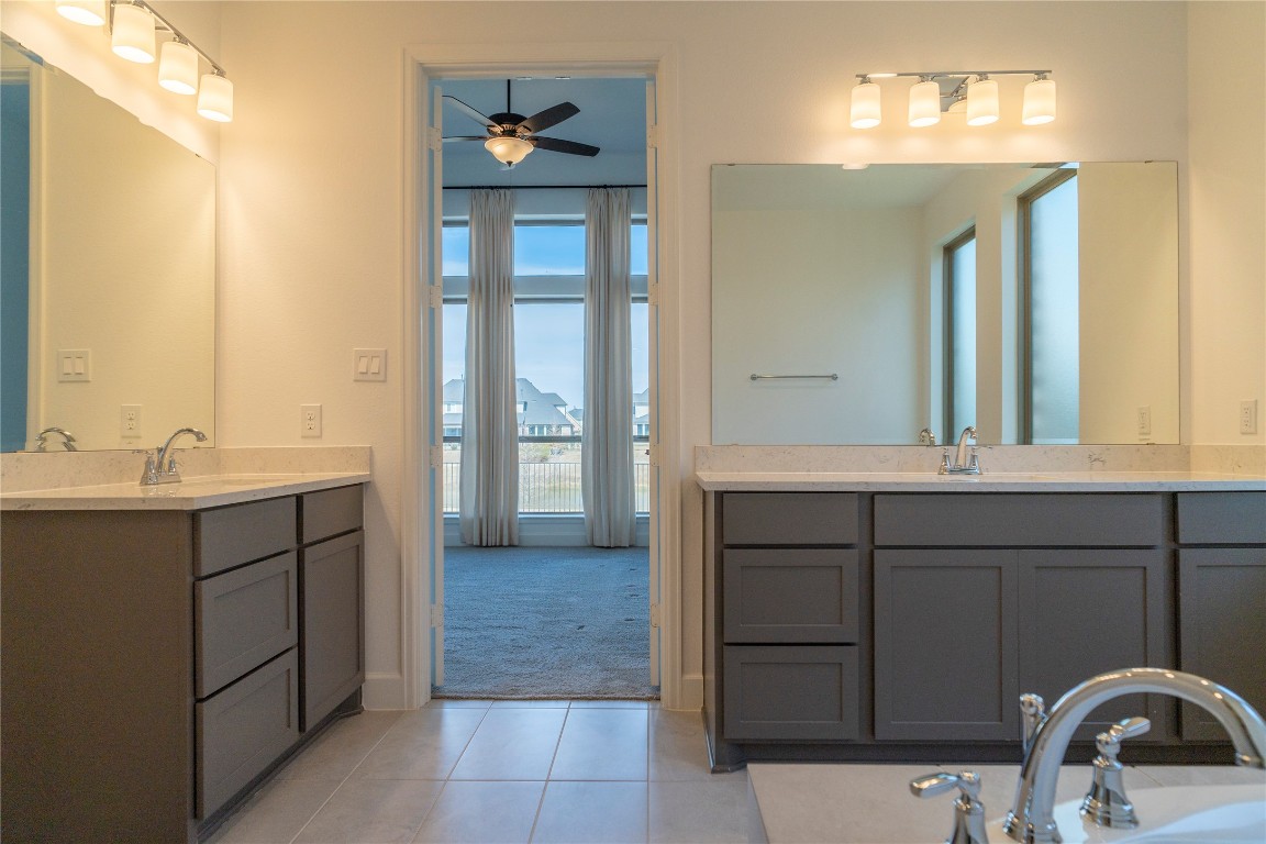 29856 Smoky Ridge Road Fulshear, TX 77441 - Photo 13 of 36 a bathroom with a sink and a mirror