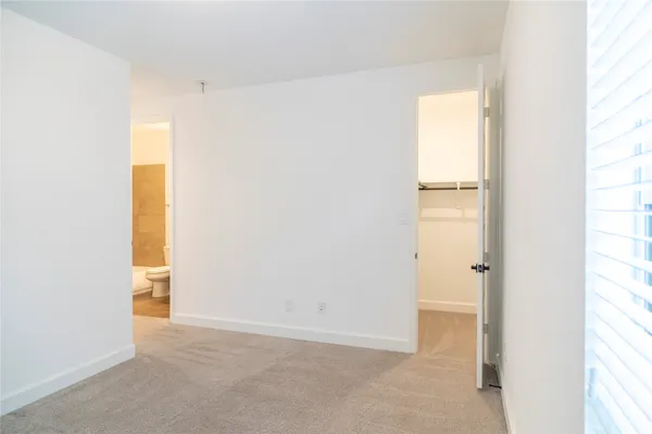 a view of an empty room and a window