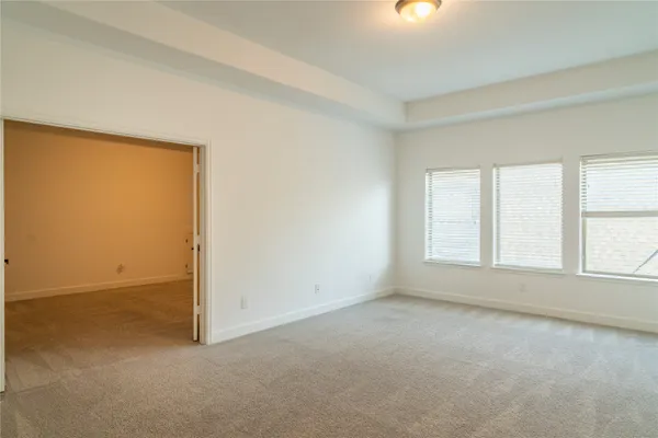 an empty room with windows and closet